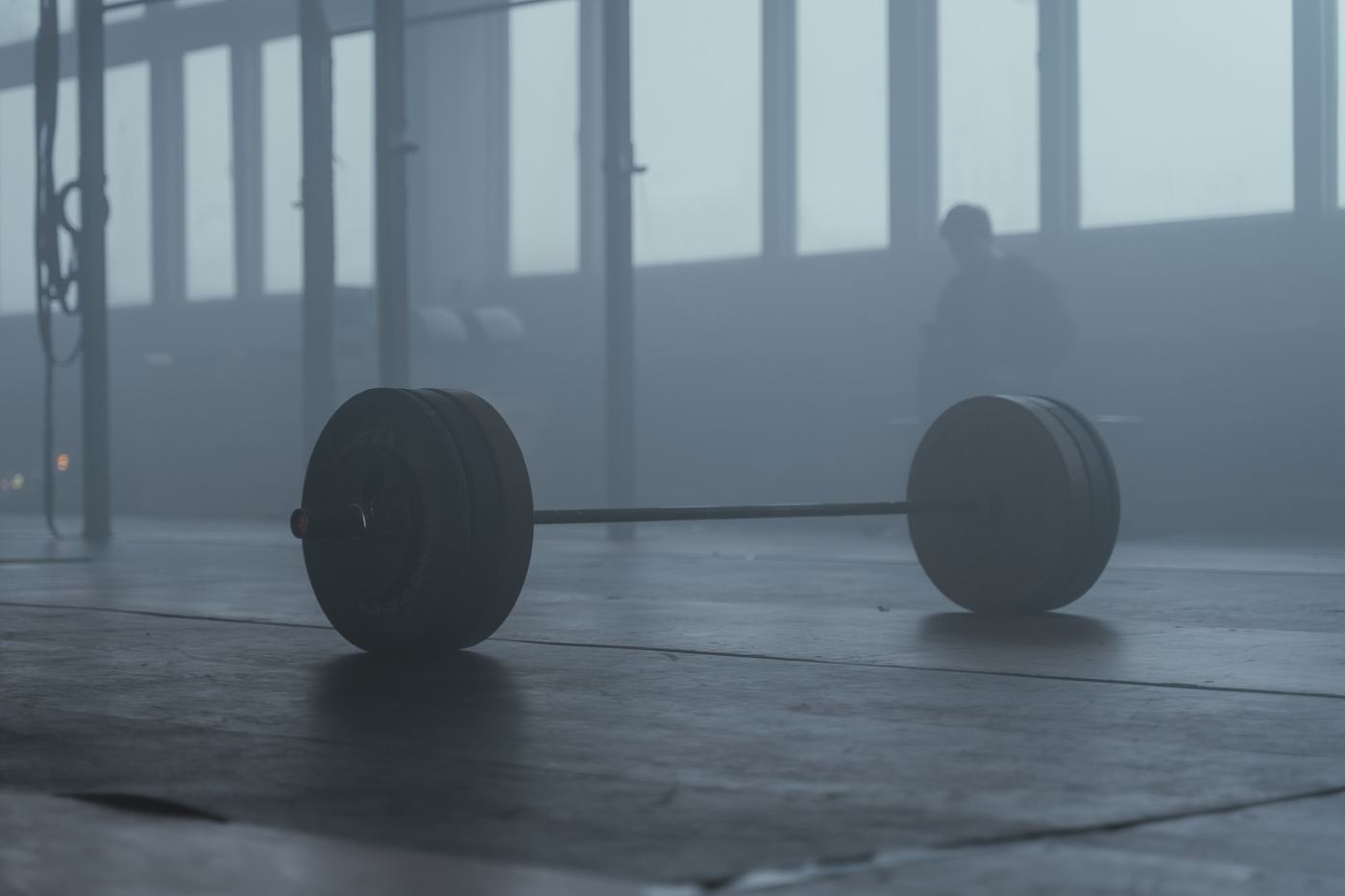 Barbell loaded with weight plates in a quiet gym