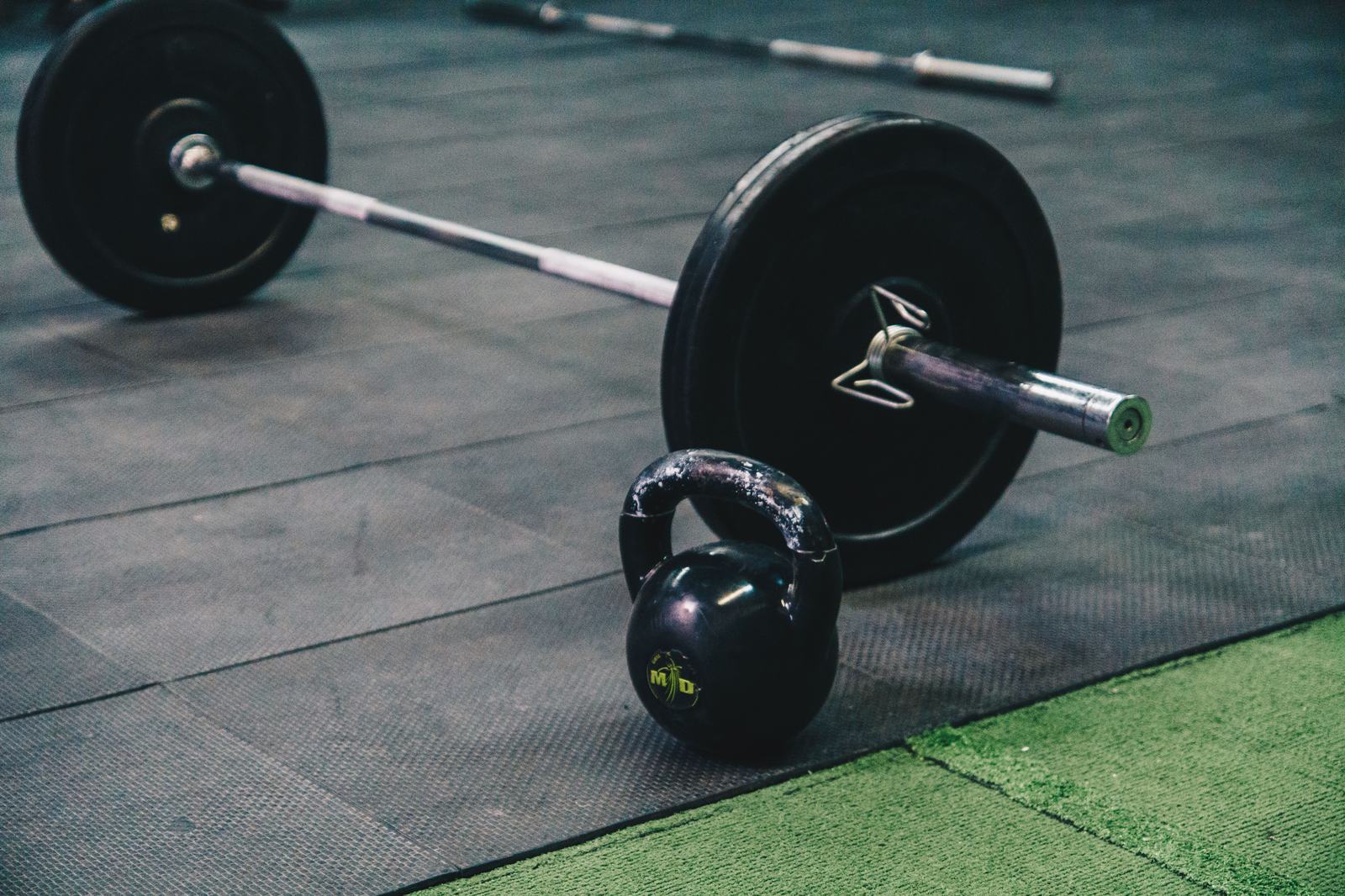 Barbell and kettlebell on the gym floor